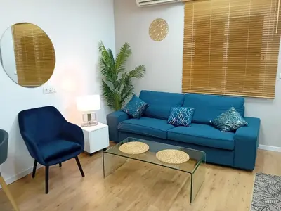 a blue couch and a chair in a living room at Bonavista Montgat in Montgat