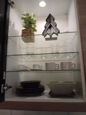 a glass shelf with dishes and plants on it at Bonavista Montgat in Montgat