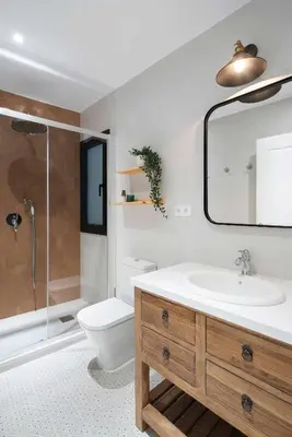 a bathroom with a sink and a toilet and a mirror at Casa familiar junto al mar en Arenys de Mar in Arenys de Mar