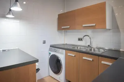 a kitchen with a sink and a washing machine at Comodidad y estilo en Gava near the beach 10 minutes in Viladecáns