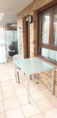 a glass table in a room with a window at Habitacion con Piscina in Sant Cugat del Vallès