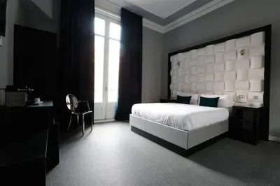 a bedroom with a white bed and a large window at Amra Barcelona Gran Via in Barcelona