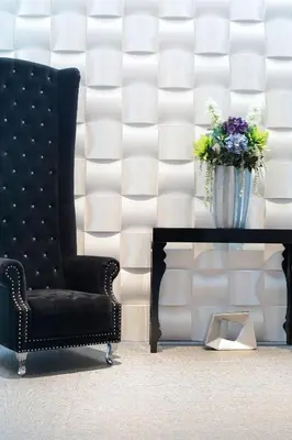 a black chair and a vase of flowers on a table at Amra Barcelona Gran Via in Barcelona