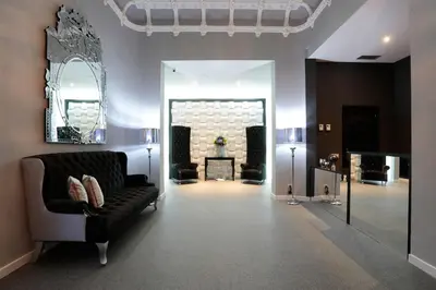 a living room with a couch and a mirror at Amra Barcelona Gran Via in Barcelona