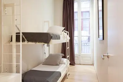 a room with two bunk beds and a window at Easysleep Borne in Barcelona
