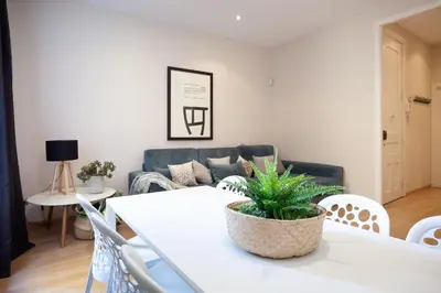 a living room with a white table and a couch at Easysleep Borne in Barcelona