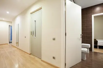 a bathroom with white doors and a toilet at Easysleep Borne in Barcelona