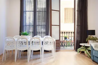 a dining room with a white table and chairs at Easysleep Borne in Barcelona