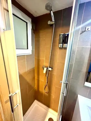a shower with a glass door in a bathroom at B3 planta baja al lado del metro in Barcelona