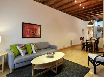 a living room with a couch and a table at Beautiful apartment in Eixample in Barcelona
