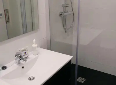 a bathroom with a white sink and a shower at Beautiful apartment in Eixample in Barcelona