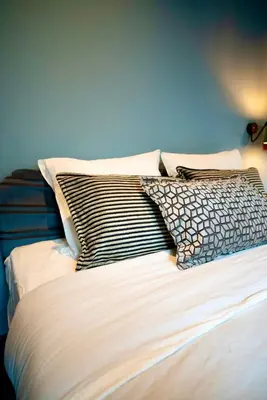 a bed with four pillows on top of it at Hotel Lincoln Lounge in Barcelona