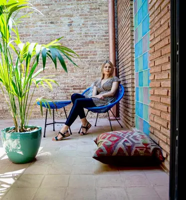 a woman sitting in a chair on a patio at Hotel Lincoln Lounge in Barcelona