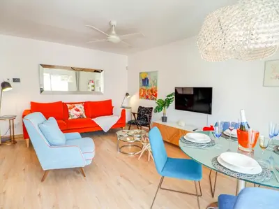 a living room with a couch and a table at Happy Diamond by Hello Homes Sitges in Sitges