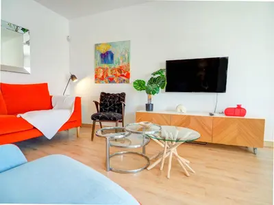 a living room with a couch and a tv at Happy Diamond by Hello Homes Sitges in Sitges