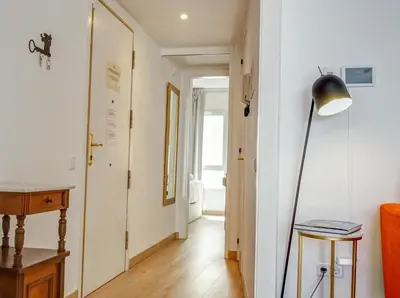a living room with a floor lamp and a hallway at Happy Diamond by Hello Homes Sitges in Sitges