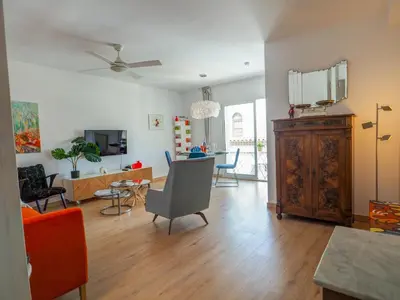 a living room with a couch and a table at Happy Diamond by Hello Homes Sitges in Sitges