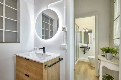 a bathroom with a sink and a mirror at BBarcelona Sagrada Familia Garden Apartment in Barcelona