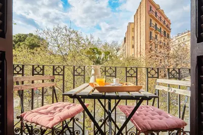 a table with two chairs on a balcony at BBarcelona Sagrada Familia Garden Apartment in Barcelona