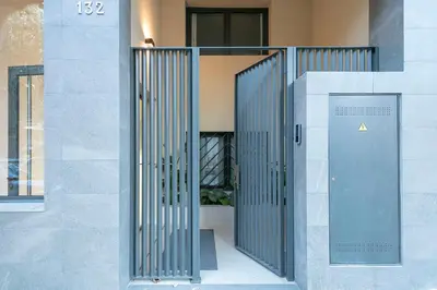 an entrance to a building with a metal door at YOUR HOME- Apartment Camp Nou Baj in Hospitalet de Llobregat