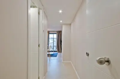 a white hallway with a door to a room at YOUR HOME- Apartment Camp Nou 1 in Hospitalet de Llobregat
