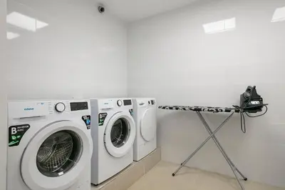 a laundry room with a washer and dryer at YOUR HOME- Apartment Camp Nou 2b in Hospitalet de Llobregat