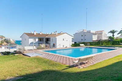 a swimming pool in front of a house at Romantic: Precioso frente al mar in Sitges