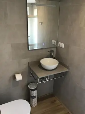 a bathroom with a sink and a mirror and a toilet at 1201 - Encantador Apartamento en Poble Nou in Barcelona