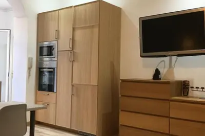 a large wooden cabinet with a television on top of it at 1201 - Encantador Apartamento en Poble Nou in Barcelona