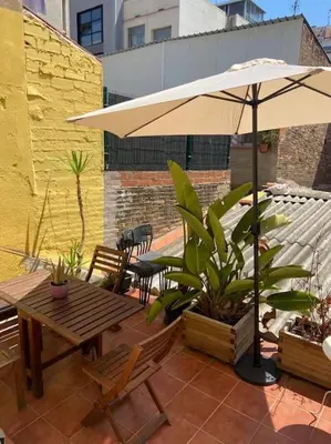 a patio with an umbrella and a table and chairs at 1201 - Encantador Apartamento en Poble Nou in Barcelona