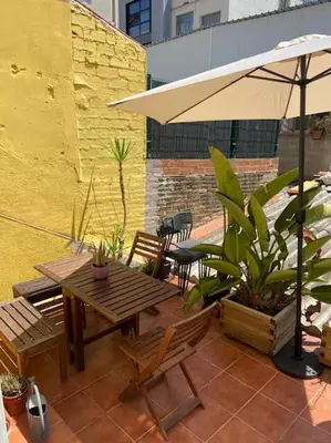 a patio with an umbrella and a table and chairs at 1201 - Encantador Apartamento en Poble Nou in Barcelona