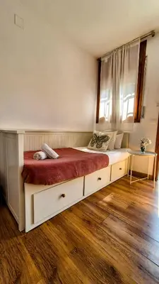 a bedroom with a large white bed with a red blanket at Vila Sitges, big house with pool in Sitges