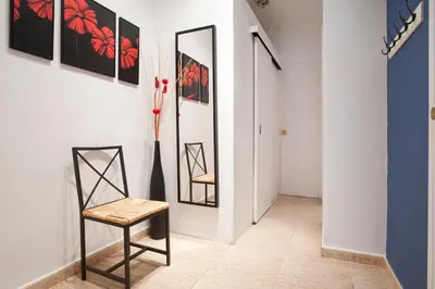 a chair in a hallway with a mirror at Rainbow in Barcelona