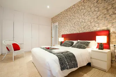a bedroom with a large bed and a brick wall at Rainbow in Barcelona