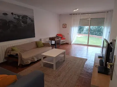 a living room with a couch and a table at Casa Roure-4BR-Piscina privada-BBQ-Vistas Mar in Sant Cebrià de Vallalta