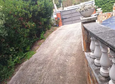 a road with a vase on a railing on a house at Casa Roure-4BR-Piscina privada-BBQ-Vistas Mar in Sant Cebrià de Vallalta