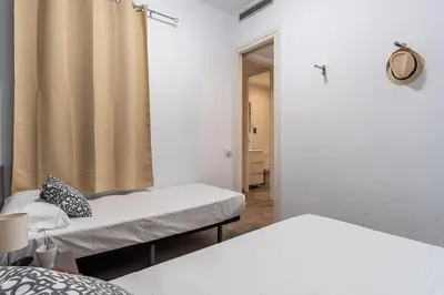 a room with two beds and a mirror at AB Marina Apartments in Barcelona