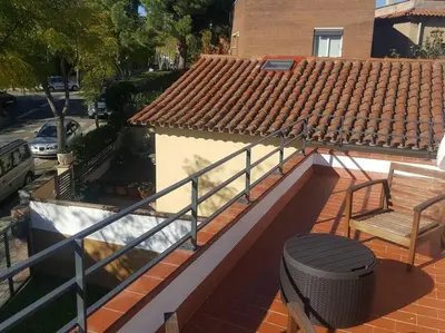 a balcony with a railing and a bench on a house at House in Sant Cugat, 25 Mins to Barcelona center in Sant Cugat del Vallès