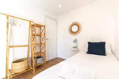 a bedroom with a bed and a mirror on the wall at Picasso Suites Cornellá in Cornellà de Llobregat