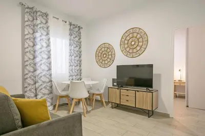a living room with a table and a television at Alcam Baro 22 in Barcelona