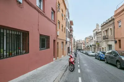 a red motorcycle parked on the side of a street at Alcam Baro 22 in Barcelona