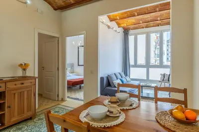 a kitchen and living room with a wooden table and chairs at 2098 - AB Sagrada Família Bofill in Barcelona