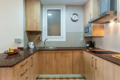 a kitchen with a sink and a clock on the wall at 2098 - AB Sagrada Família Bofill in Barcelona