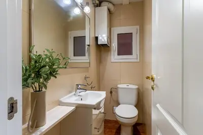 a bathroom with a toilet and a sink and a mirror at 2098 - AB Sagrada Família Bofill in Barcelona