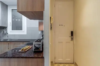a kitchen with a white door and a counter at 2098 - AB Sagrada Família Bofill in Barcelona