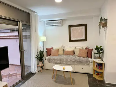 a living room with a couch and a table at Private terrace 1BR apt - 4min walk to the beach in Pineda de Mar