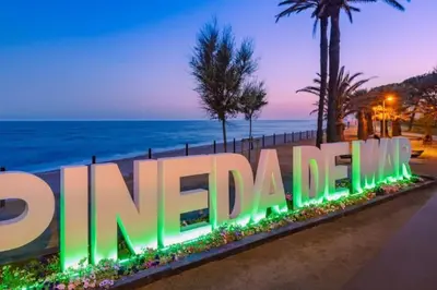 a sign with the ocean in the background at Private terrace 1BR apt - 4min walk to the beach in Pineda de Mar