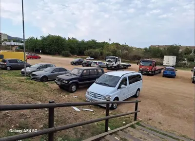 a group of cars parked in a parking lot at Private terrace 1BR apt - 4min walk to the beach in Pineda de Mar