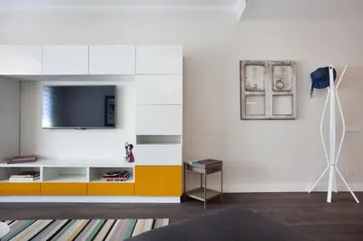 a living room with a tv on a wall at Consell de Cent Apartment in Barcelona