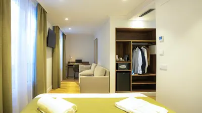 a bedroom with a bed and a chair and a closet at Casa Pince in Barcelona